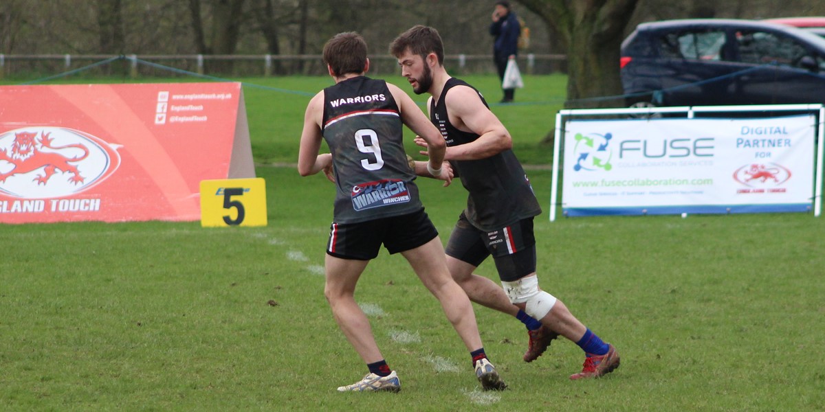 Two touch rugby players on a grass pitch